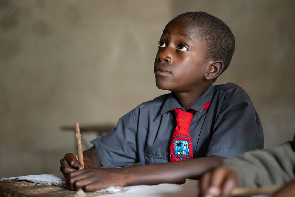 David looking up and studying in school after cleft surgery